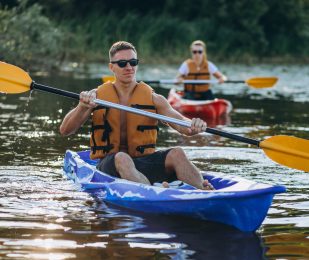 Couple together kayaking on the river